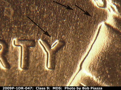 Die-stage B marker on 2009P•1DR•047 (2009 Doubled Die Reverse).