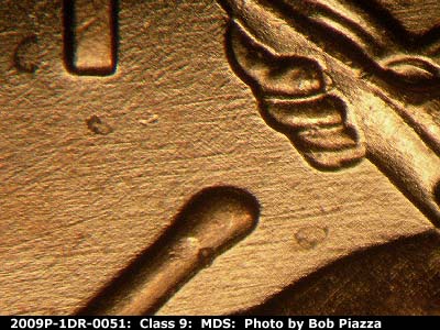 Die-stage B marker on 2009P•1DR•051 (2009 Doubled Die Reverse).