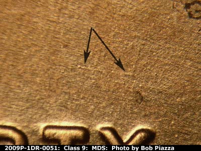 Die-stage B marker on 2009P•1DR•051 (2009 Doubled Die Reverse).