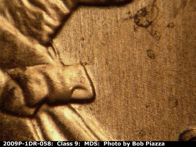 Die-stage B marker on 2009P•1DR•058 (2009 Doubled Die Reverse).