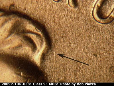 Die-stage B marker on 2009P•1DR•058 (2009 Doubled Die Reverse).