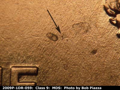 Die-stage B marker on 2009P•1DR•059 (2009 Doubled Die Reverse).
