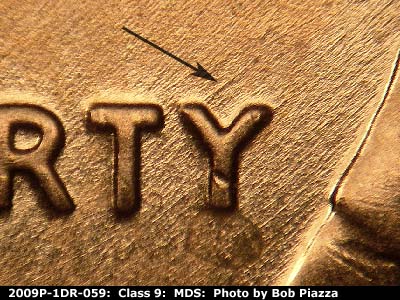 Die-stage B marker on 2009P•1DR•059 (2009 Doubled Die Reverse).