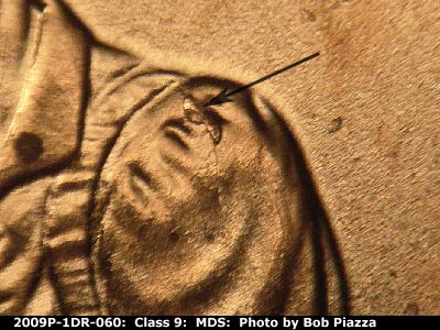 Die-stage B marker on 2009P•1DR•060 (2009 Doubled Die Reverse).