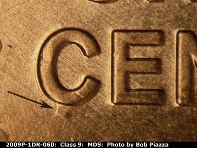Die-stage B marker on 2009P•1DR•060 (2009 Doubled Die Reverse).
