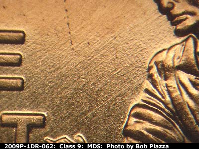 Die-stage B marker on 2009P•1DR•062 (2009 Doubled Die Reverse).