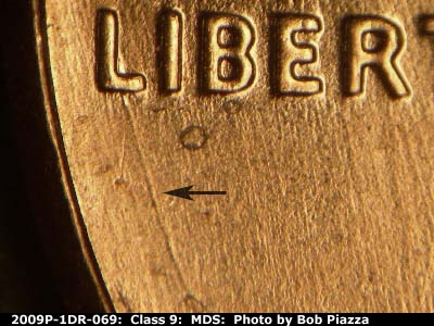 Die-stage B marker on 2009P•1DR•069 (2009 Doubled Die Reverse).