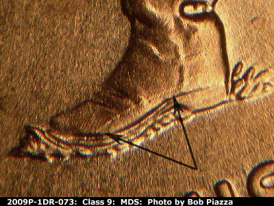 Die-stage B marker on 2009P•1DR•073 (2009 Doubled Die Reverse).