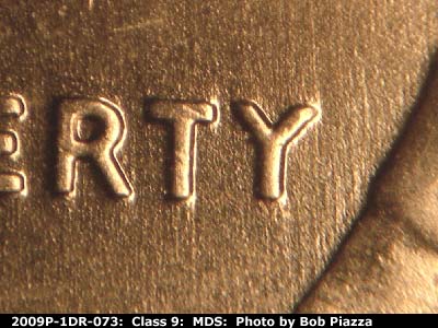 Die-stage B marker on 2009P•1DR•073 (2009 Doubled Die Reverse).