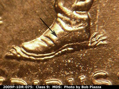 Die-stage B marker on 2009P•1DR•075 (2009 Doubled Die Reverse).
