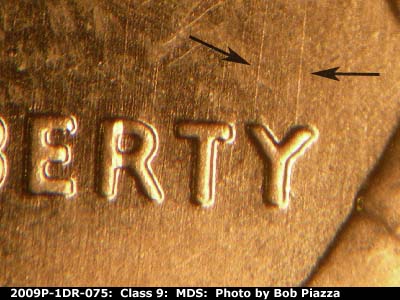 Die-stage B marker on 2009P•1DR•075 (2009 Doubled Die Reverse).