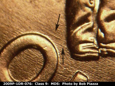 Die-stage B marker on 2009P•1DR•076 (2009 Doubled Die Reverse).
