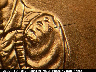 Die-stage B marker on 2009P•1DR•092 (2009 Doubled Die Reverse).