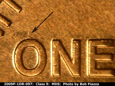 Die-stage B marker on 2009P•1DR•097 (2009 Doubled Die Reverse).