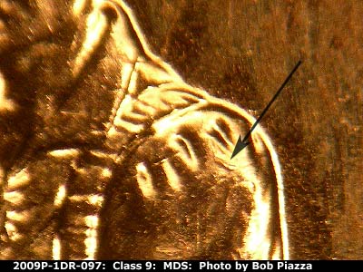 Die-stage B marker on 2009P•1DR•097 (2009 Doubled Die Reverse).