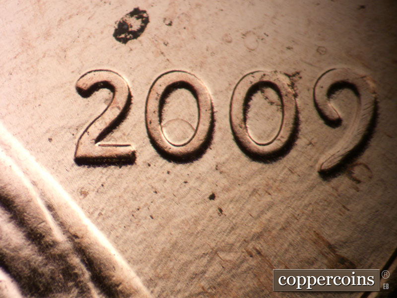 Die-stage B marker on 2009P•1DR•100 (2009 Doubled Die Reverse).