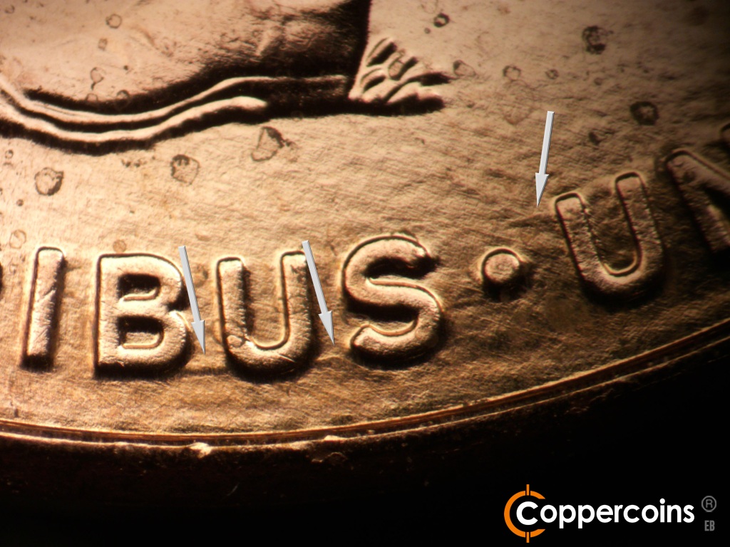 Die-stage A marker on 2009P•1DR•108 showing Die gouge conect BUS in PLURIBUS. Die gouge from top of first U in UNUM.