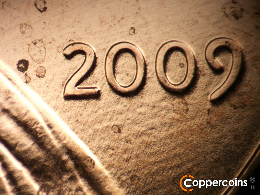 Die-stage A marker on 2009P•1DR•108 showing Light NNE die scratches from lapel to date.
