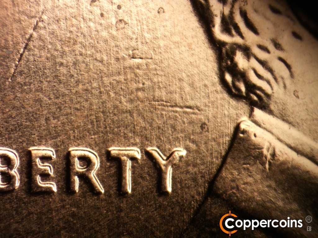 Die-stage A marker on 2009P•1DR•108 showing Light generally N/S die scratches behind neck and above RTY in LIBERTY.