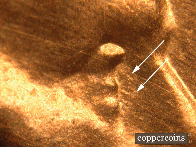 Die-stage B marker on 2016P•1DO•013 showing Northwest to southeast die scratches extend from Lincoln's eye.