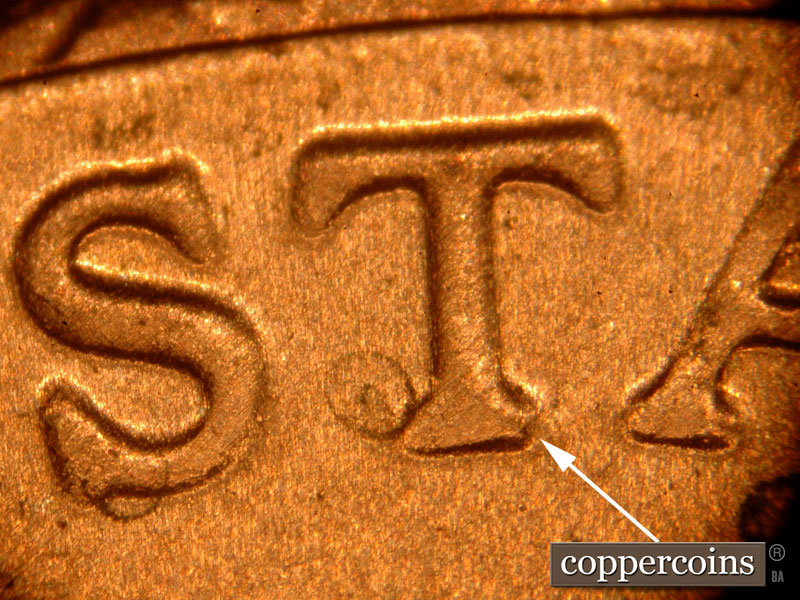 Die-stage C marker on 2018D•1DR•001 showing Notching on the bottom serif of the T in STATES.