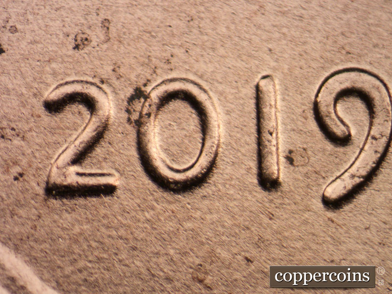 Die-stage A marker on 2019P•1DO•006 showing Very slight spread seen in the date.