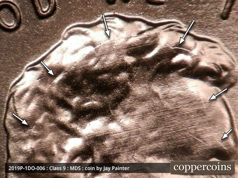 Die-stage B marker on 2019P•1DO•006 showing A die crack runs through Lincoln's hair and continues along his forehead.
