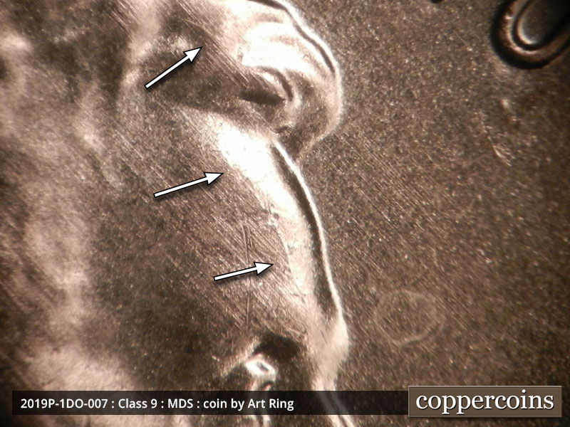Die-stage B marker on 2019P•1DO•007 showing A faint die break running north to south through Lincoln's forehead.