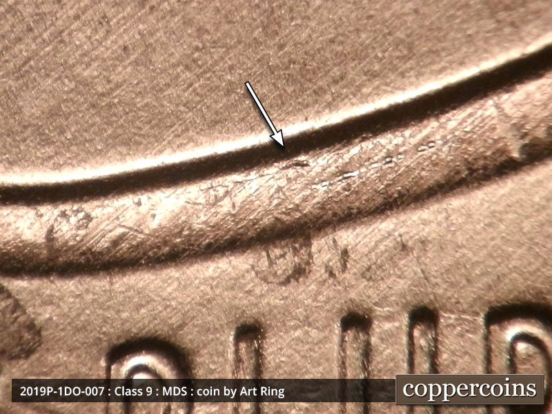 Die-stage B marker on 2019P•1DO•007 showing A very small die chip on the top left of the shield.