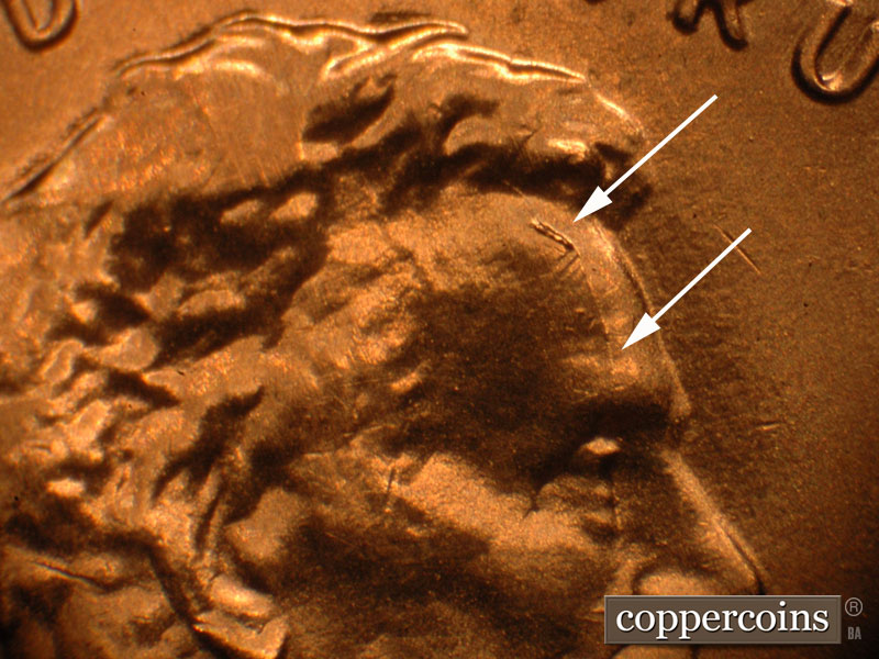 Die-stage A marker on 2019P•1DO•010 showing A die break through Lincoln's forehead.