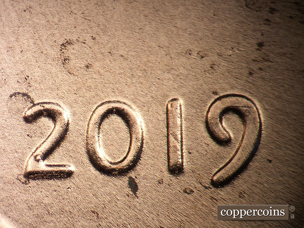 Die-stage B marker on 2019P•1DO•011 showing Moderate extra thickness on date.