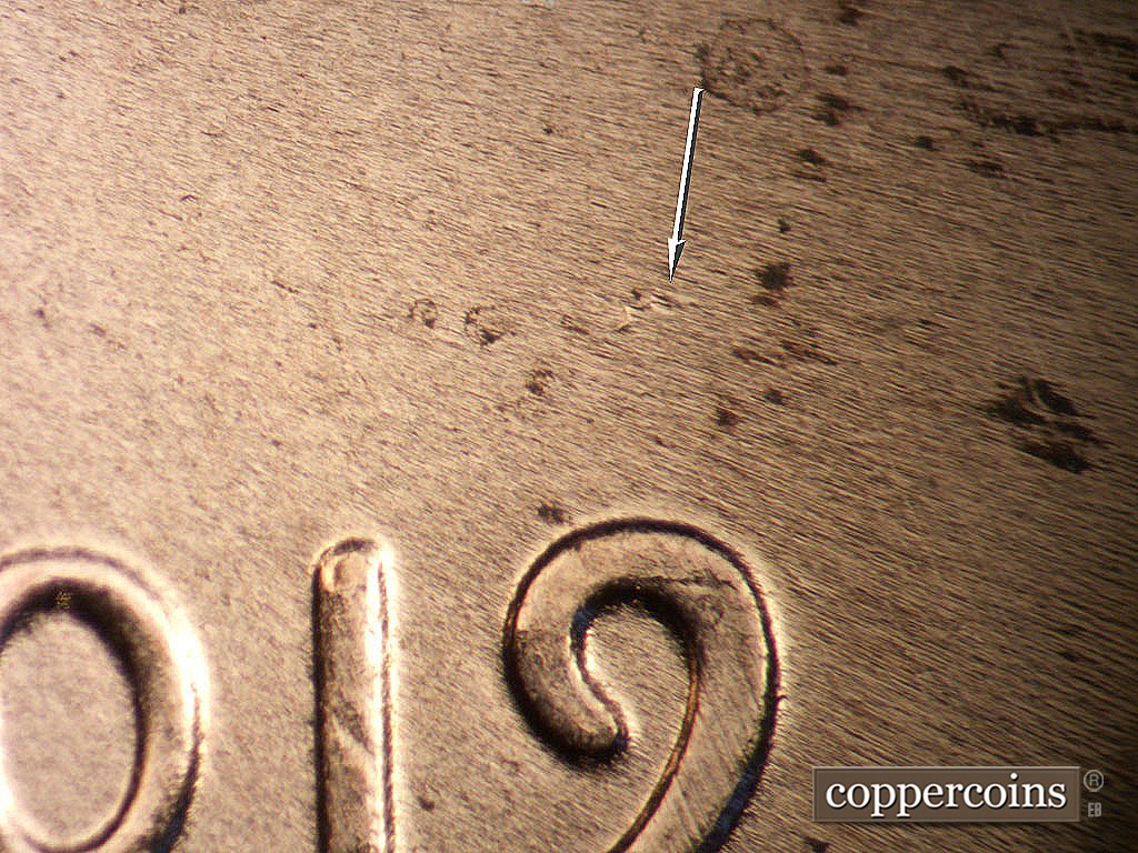 Die-stage B marker on 2019P•1DO•011 showing die dot above 9 in date.