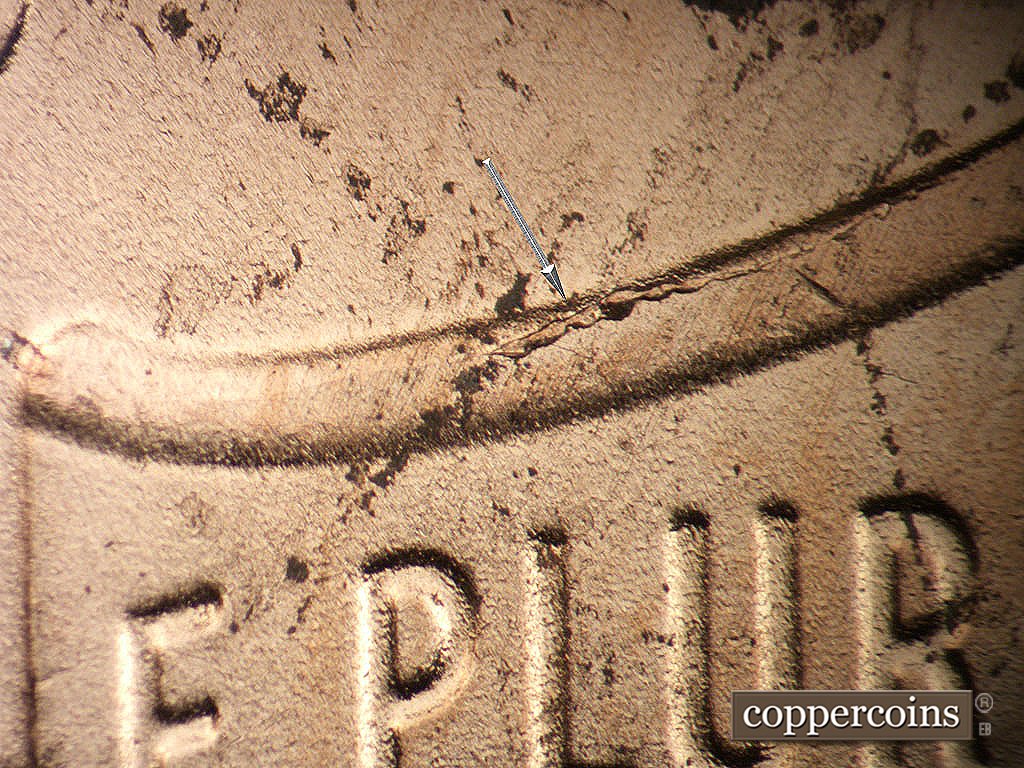 Die-stage B marker on 2019P•1DO•011 showing Die crack on top left of shield.