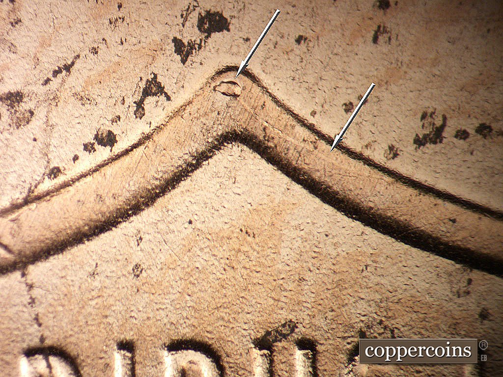 Die-stage B marker on 2019P•1DO•011 showing Die chip and chrack on top center of shield.