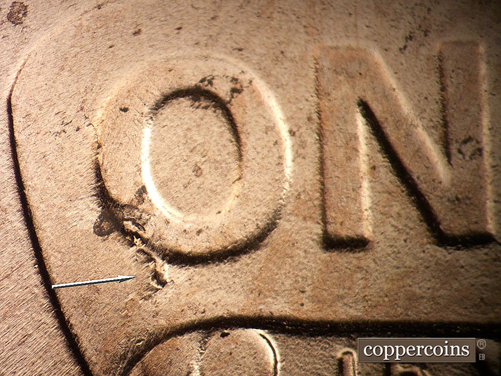 Die-stage B marker on 2019P•1DO•011 showing Die crack from O in ONE.