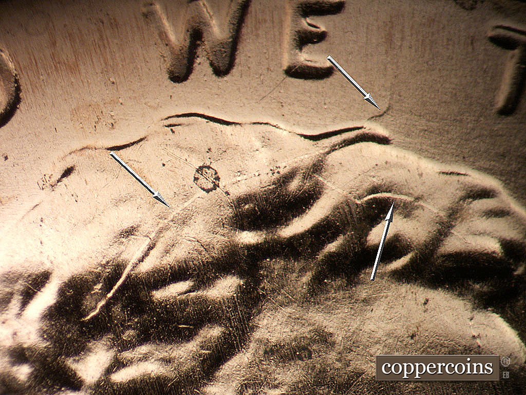 Die-stage C marker on 2019P•1DO•012 showing DIe cracks in hair into field between WE and TRUST.