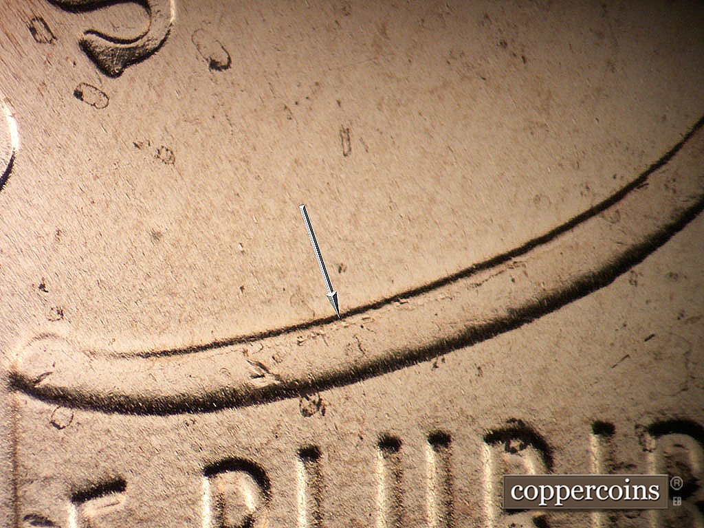 Die-stage C marker on 2019P•1DO•012 showing Light die crack on upper left of shield.