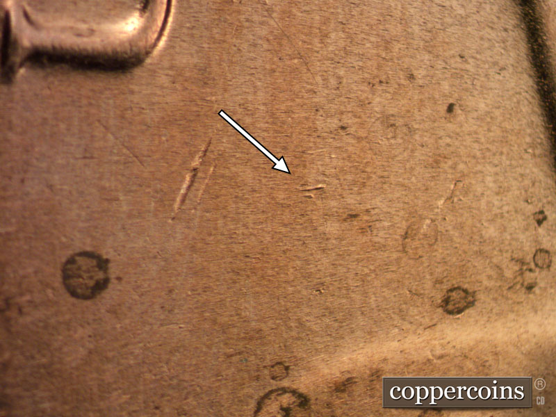 Die-stage B marker on 2020D•1DR•001 showing A trio of small die dots make a crow's foot between the U of UNITED and the O of ONE.