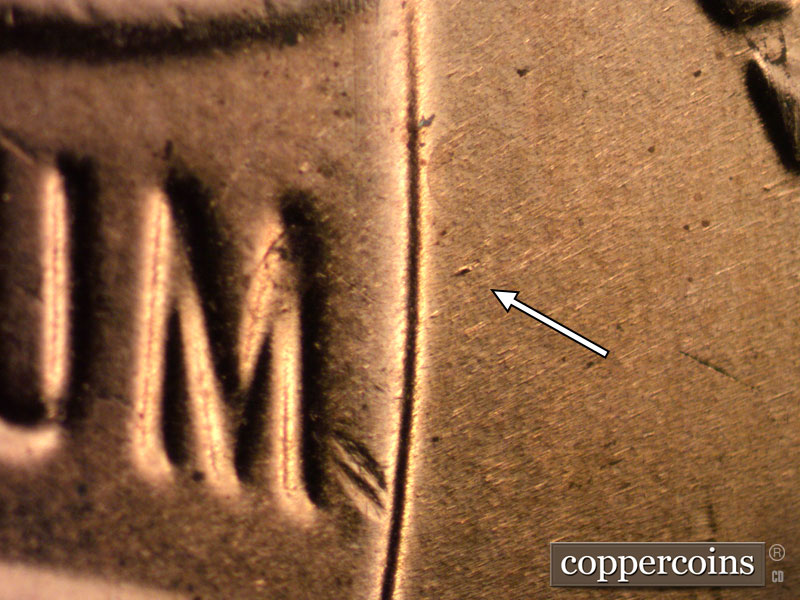 Die-stage B marker on 2020D•1DR•001 showing A heavy die dot shows in the field just to the right of the M of UNUM.