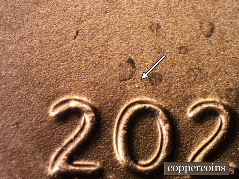 Die-stage B marker on 2020D•1DR•001 showing A heavy die dot shows just to the north of the first zero of the date.