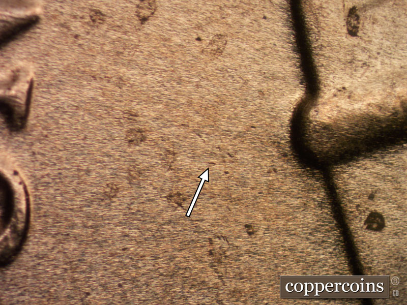 Die-stage B marker on 2020D•1DR•004 showing A die dot shows in the field to the left of the lower crown border.