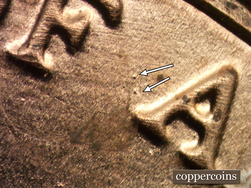 Die-stage B marker on 2020D•1DR•004 showing Two die dots to the left of the first A of AMERICA.