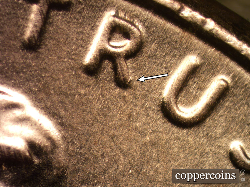 Die-stage B marker on 2020D•1DR•004 showing Die damage shows on the diagonal leg of the R of TRUST.