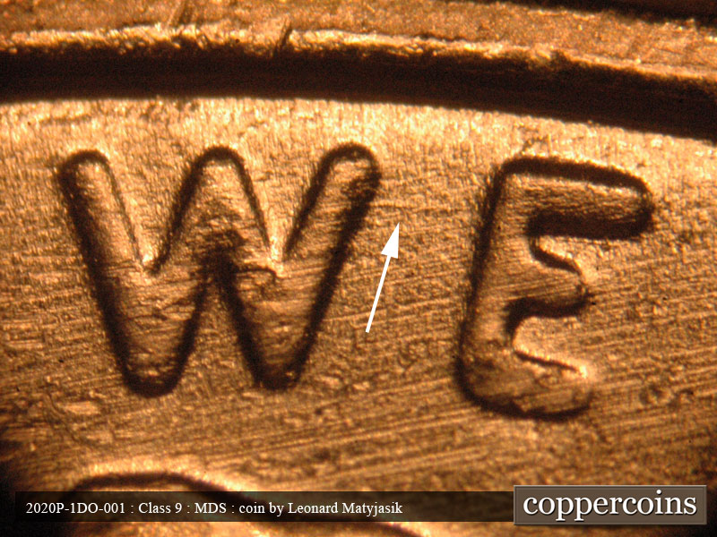 Die-stage B marker on 2020P•1DO•001 showing Small Die scratch connects the upper letters of WE.