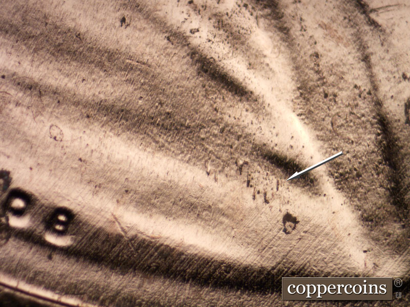 Die-stage B marker on 2020P•1DO•002 showing Die dots in shoulder fold.