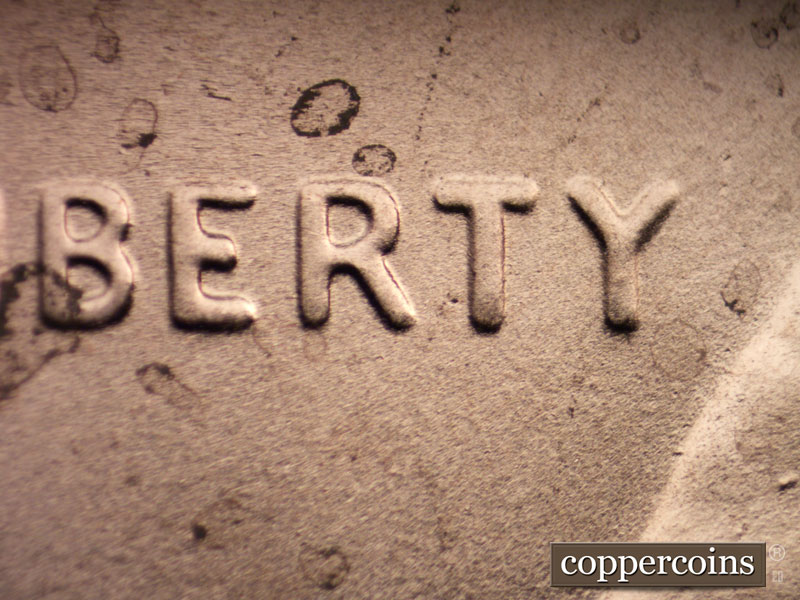 Die-stage B marker on 2020P•1DO•002 showing Mild doubling of LIBERTY.