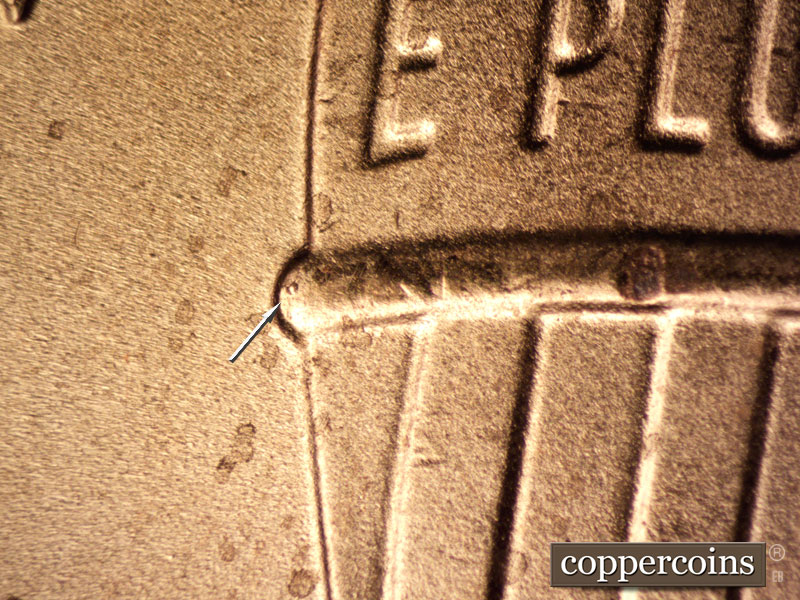 Die-stage B marker on 2020P•1DO•003 showing Die chip on west side of shield.