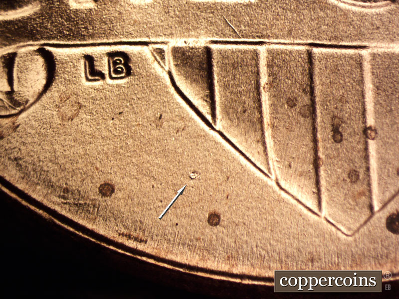 Die-stage B marker on 2020P•1DO•003 showing Die chip in field SW of shield.