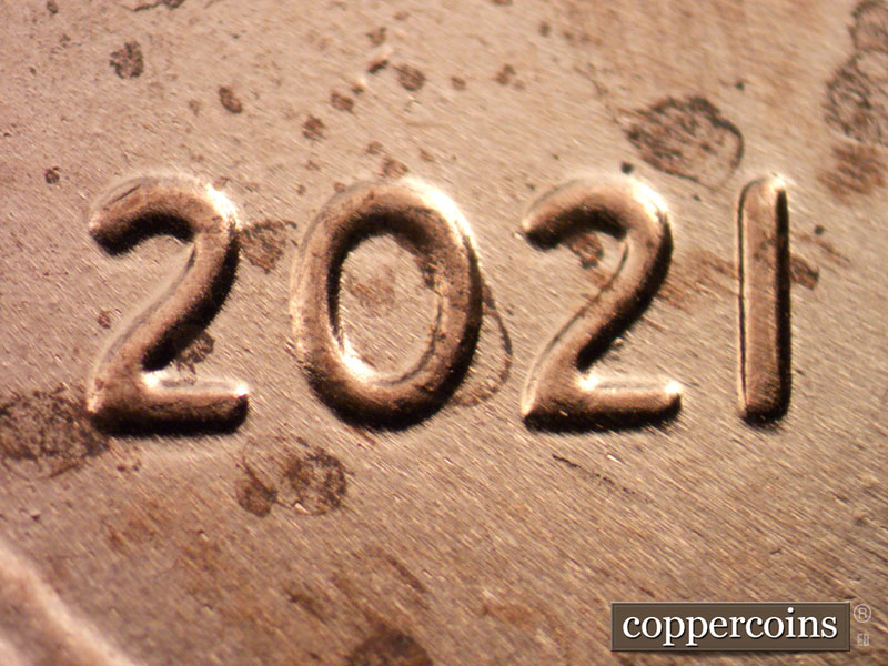 Die-stage C marker on 2021P•1DO•001 showing Light extra thickness on 20 in date, Die dot on second 2 in date.