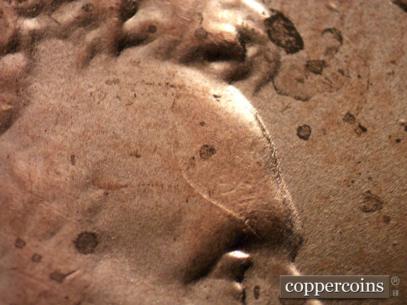 Die-stage C marker on 2021P•1DO•001 showing Die crack on forehead.